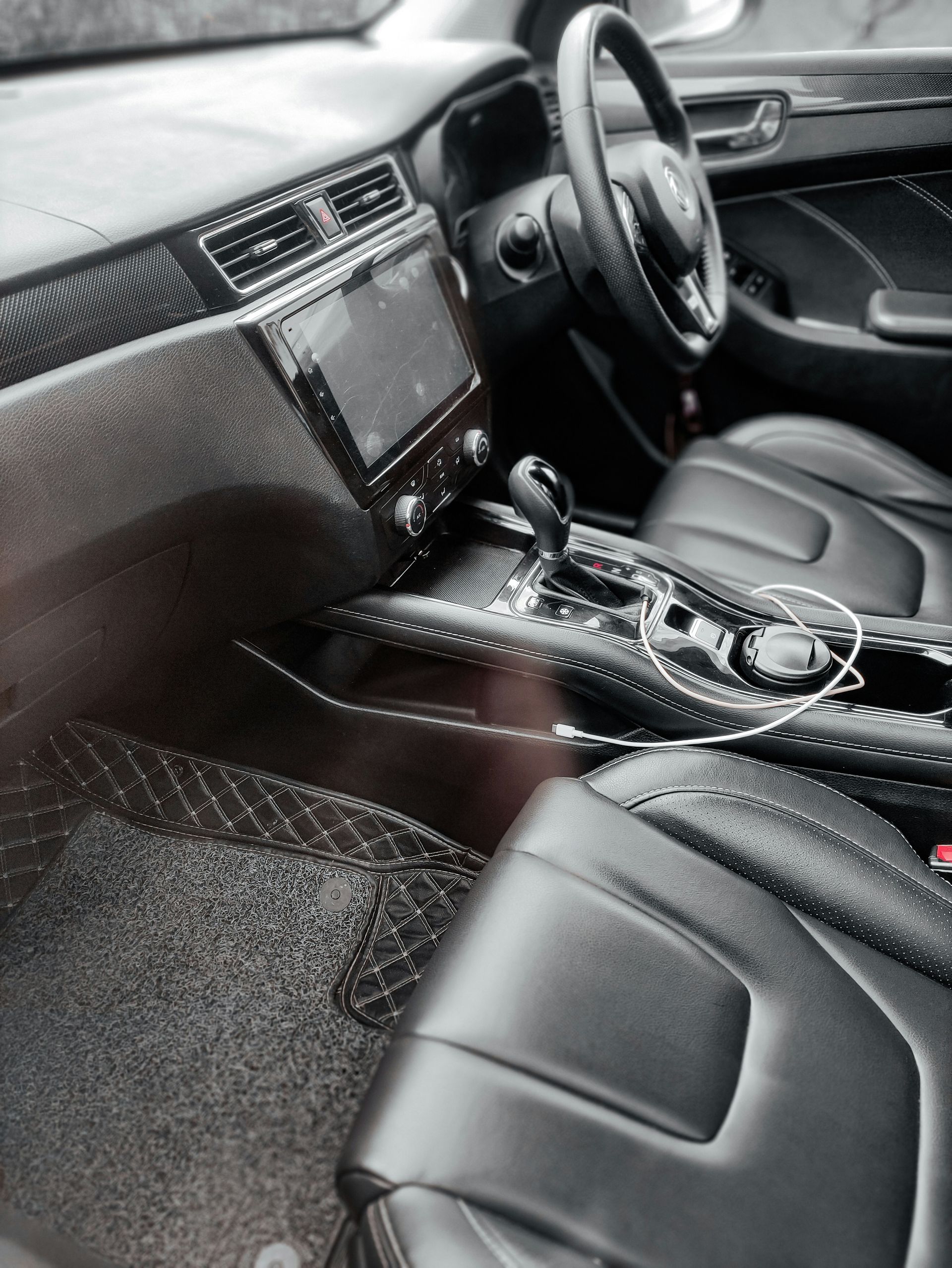 the interior of a car with black leather seats